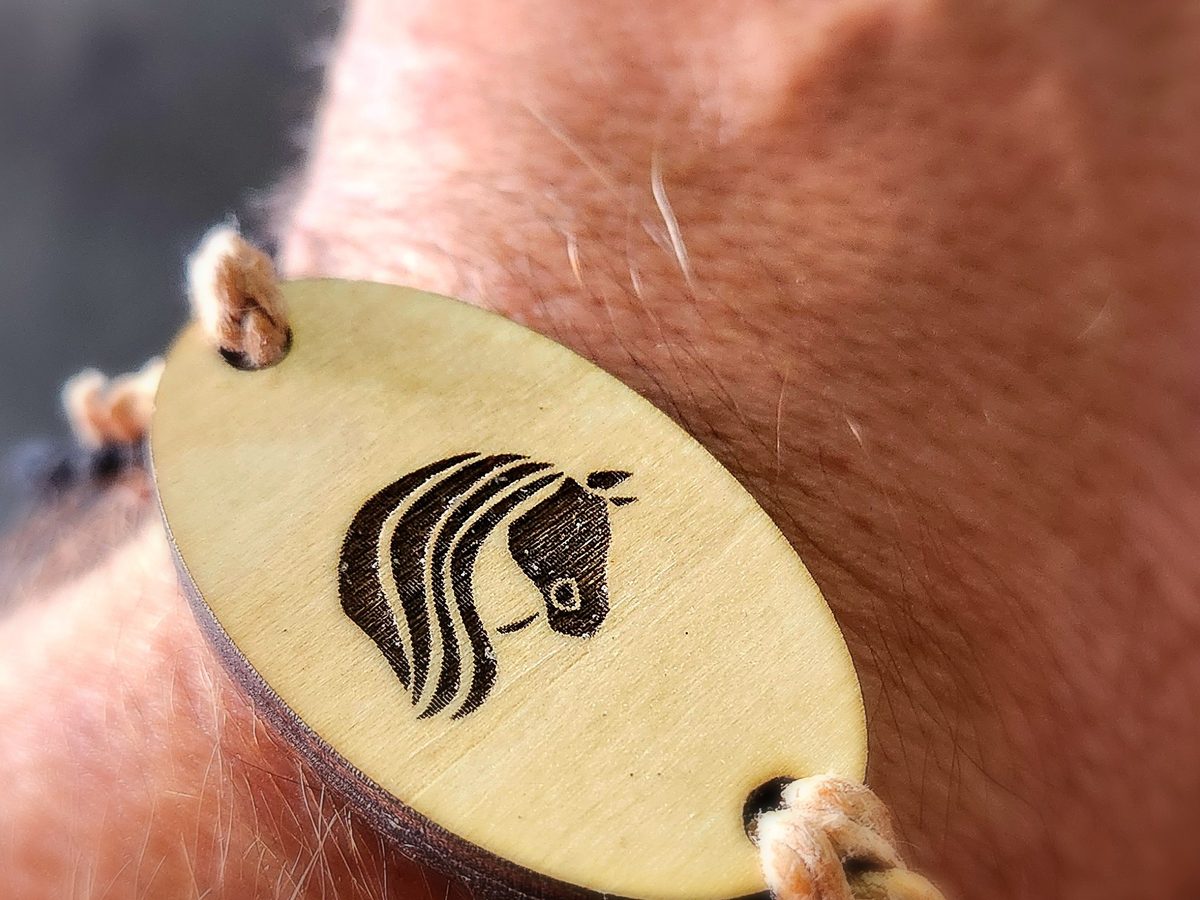 Wood NFC bracelet with engraved horse logo on braided cord